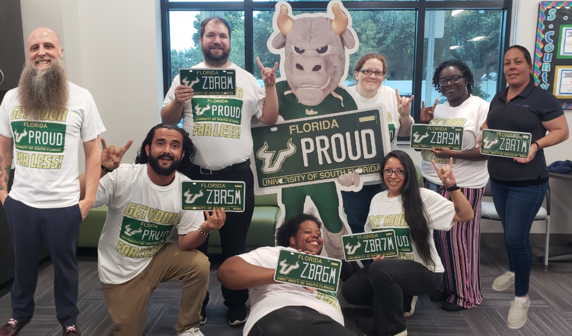 Tax Collector Team with Rocky cardboard cutout and USF Specialty plates